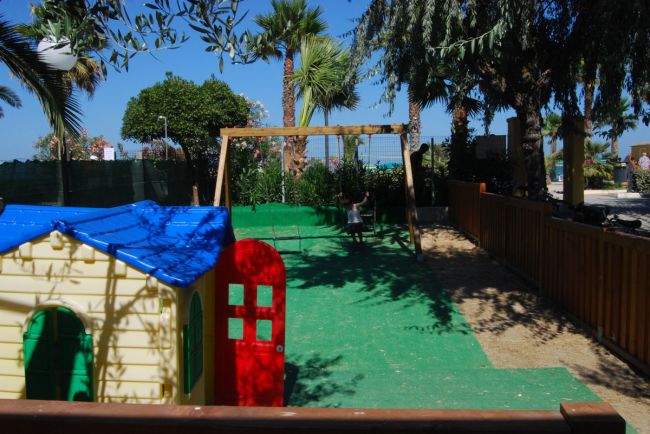 Playground with playhouse and swings.