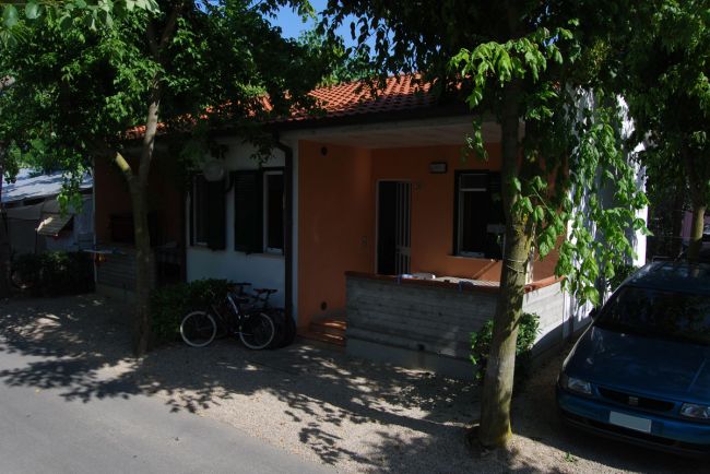 Casetta arancione con veranda e bici.