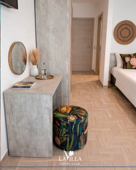 Toeletta con sgabello colorato e specchio.